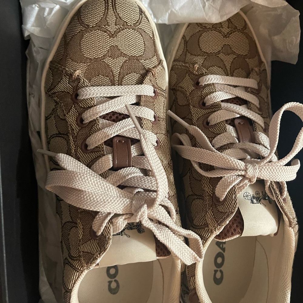 Khaki saddle coach low top sneakers.